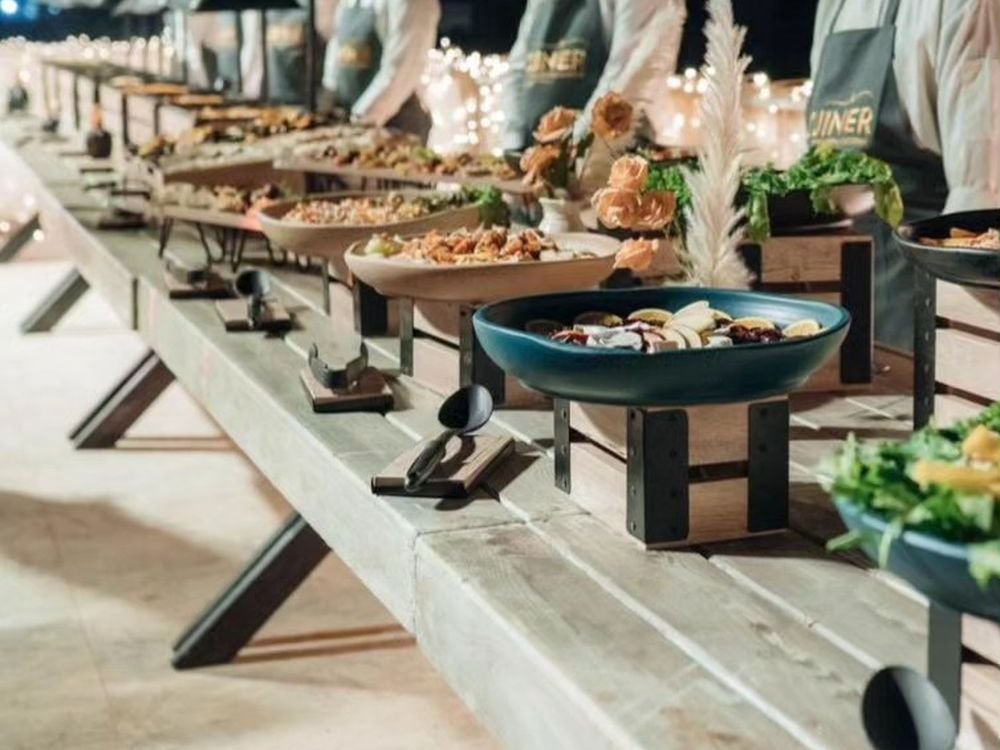 Uniformed waiters serving a corporate buffet